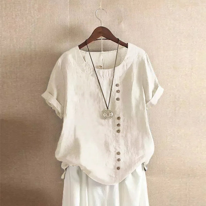 Stijlvolle damesblouse met korte mouwen, Peter Pan kraag en decoratieve knoopdetails. Ideaal voor een casual chic zomerlook.
