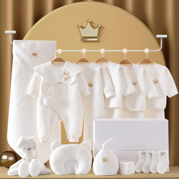 Luxe babycadeauset in geschenkverpakking met romper, muts, deken en knuffel voor pasgeborenen.