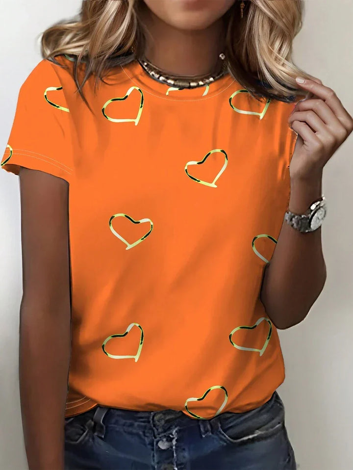 Casual oranje dames T-shirt met rechte pasvorm en kleurrijke hartjesprint. Comfortabele top met korte mouwen.