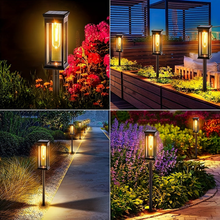 Set van 4 solar tuinlampen discreet geplaatst tussen planten in een tuin, overdag gezien.