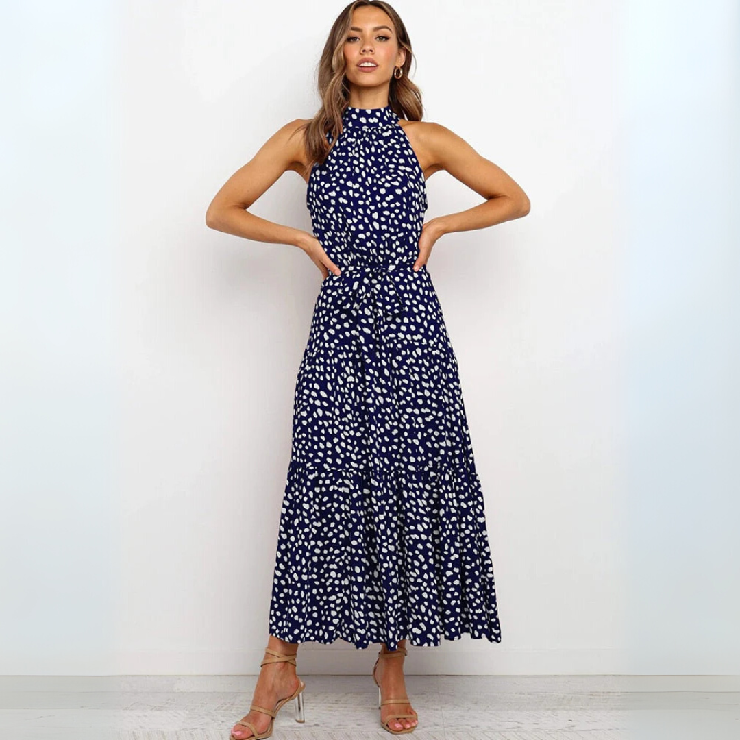 Mouwloze dames midi-jurk met stippenprint, perfect voor een casual dag of een chique avondje uit.