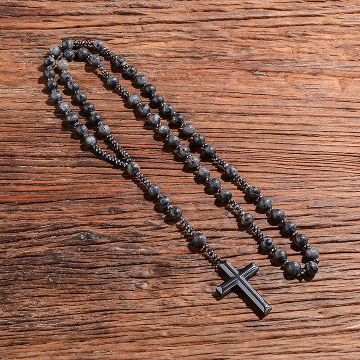 Man draagt tijgeroog en lapis lazuli rozenkrans halsketting met kruis. Spirituele modeaccessoire.