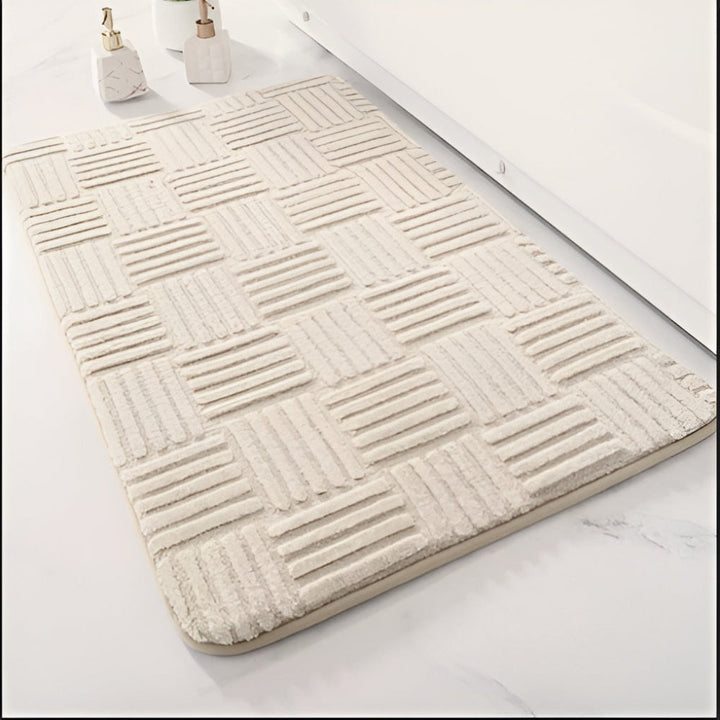 Antislip badmat van absorberend katoen, verkrijgbaar in wit, grijs, beige. Machinewasbaar en sneldrogend.