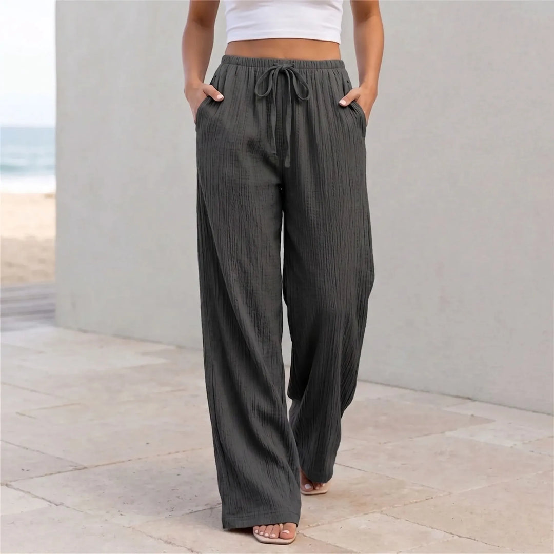 Dames palazzo broek met wijde pijpen, elastische taille en trekkoord, ideaal voor een casual zomerlook.