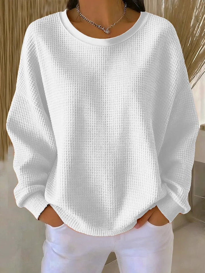 Achterkant van een comfortabele dames gebreide trui met textuur en relaxte pasvorm. Perfecte herfst casual mode.