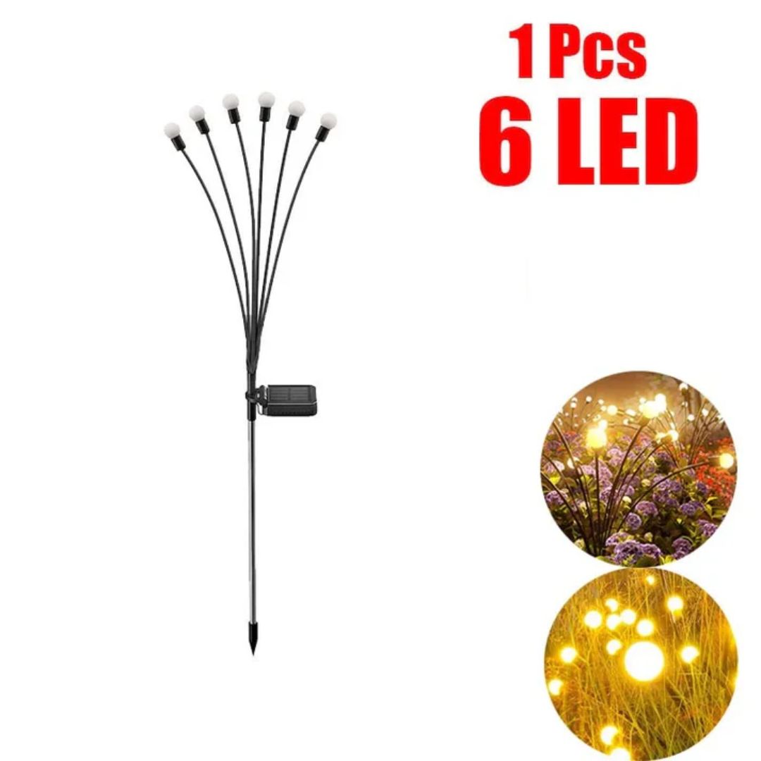Zonne LED tuinlamp met vuurwerk effect bij terras, perfecte sfeerverlichting voor gezellige avonden.
