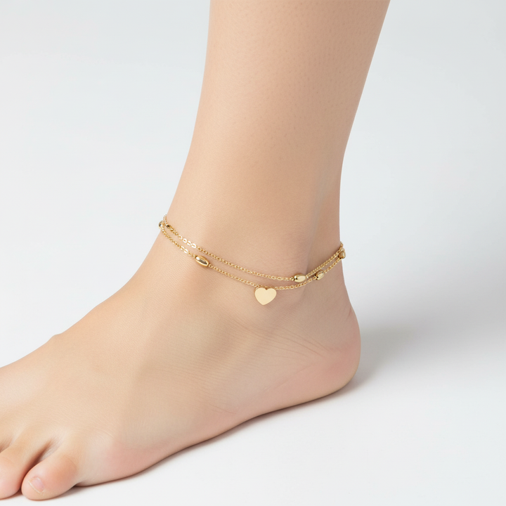 Sterling zilveren dames enkelbandje met dubbele ketting en glanzende hartbedel. Stijlvol accessoire.