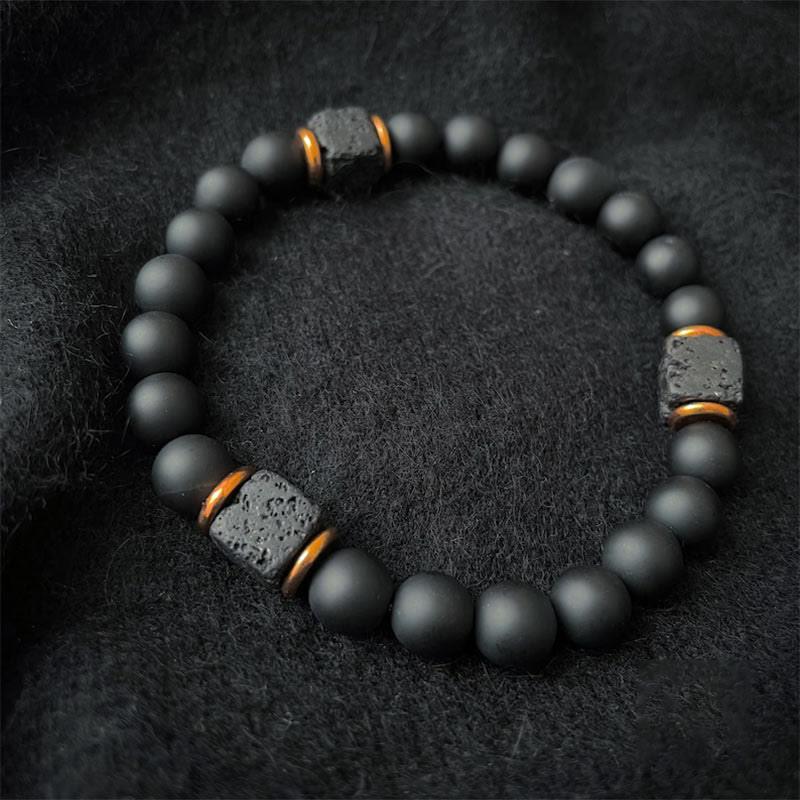 Unisex onyx & lavasteen balans armband, zwart natuursteen sieraad voor dames en heren, elegant en verstelbaar.