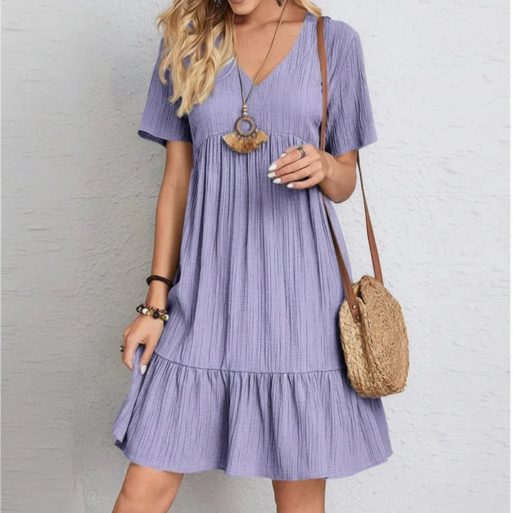Dames retro jurk met V-hals en afslankend effect. Elegante pasvorm voor zomer, lente of feest.
